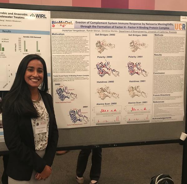Jaya in front of her poster. Thumbnail